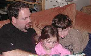 Kate, Kieran, and Daddy Reading